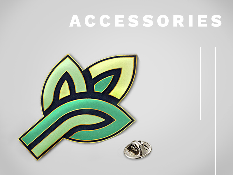 Text: Accessories; Image: Company logo enamel pin with backing.