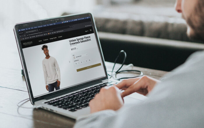 man researching crewnecks on internet